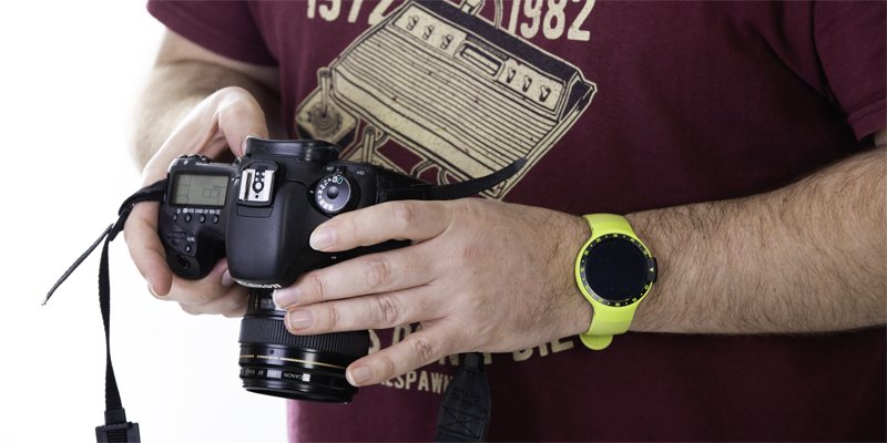 Close-up of a professional camera in a photographers hands