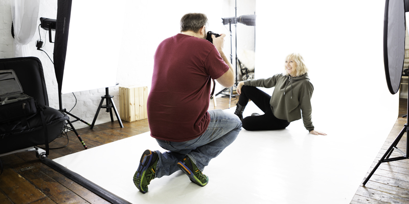 A photographer taking photos of their client in our studio