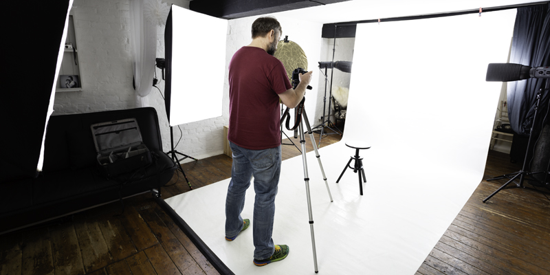Wide view of our studio with a photographer setting up
